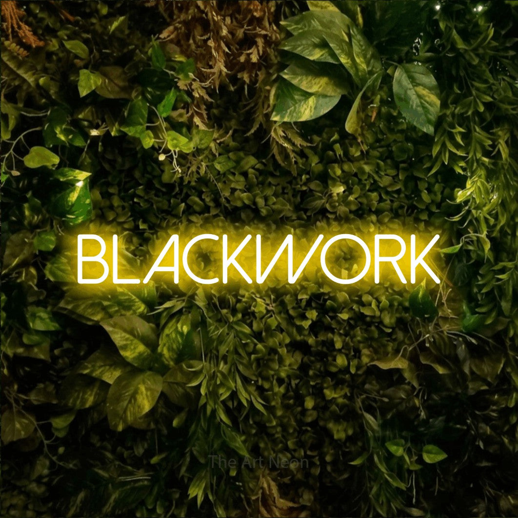 LED neon sign reading “Blackwork”, arranged in a single line.