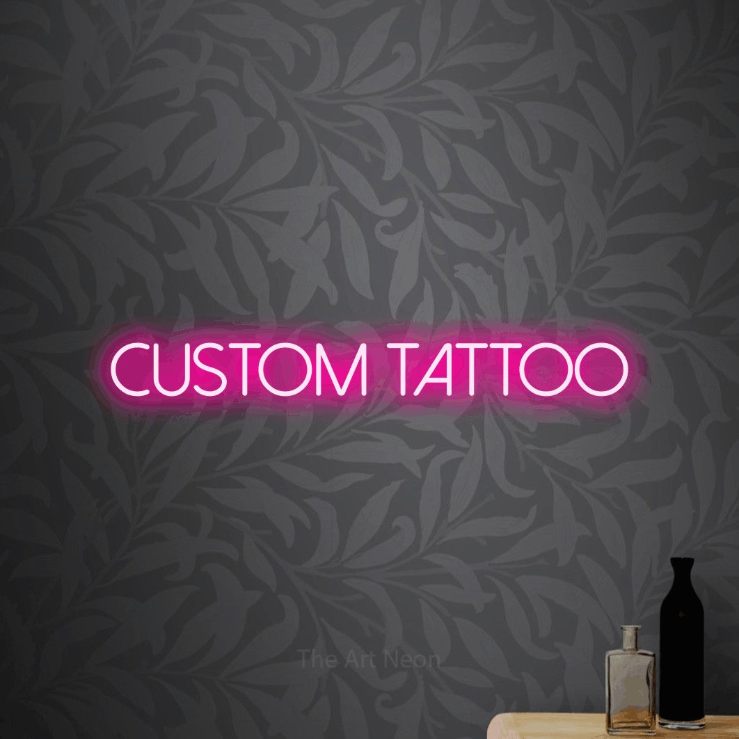 LED neon sign reading “Custom tattoo”, arranged in a single line.