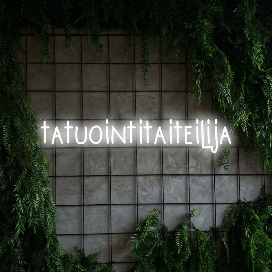 LED neon sign reading “tatuointitaiteilija”, arranged in a single line.