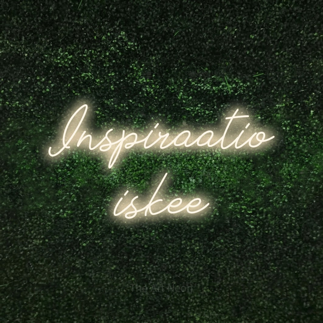LED neon sign reading “Inspiraatio iskee”, arranged in 2 lines.