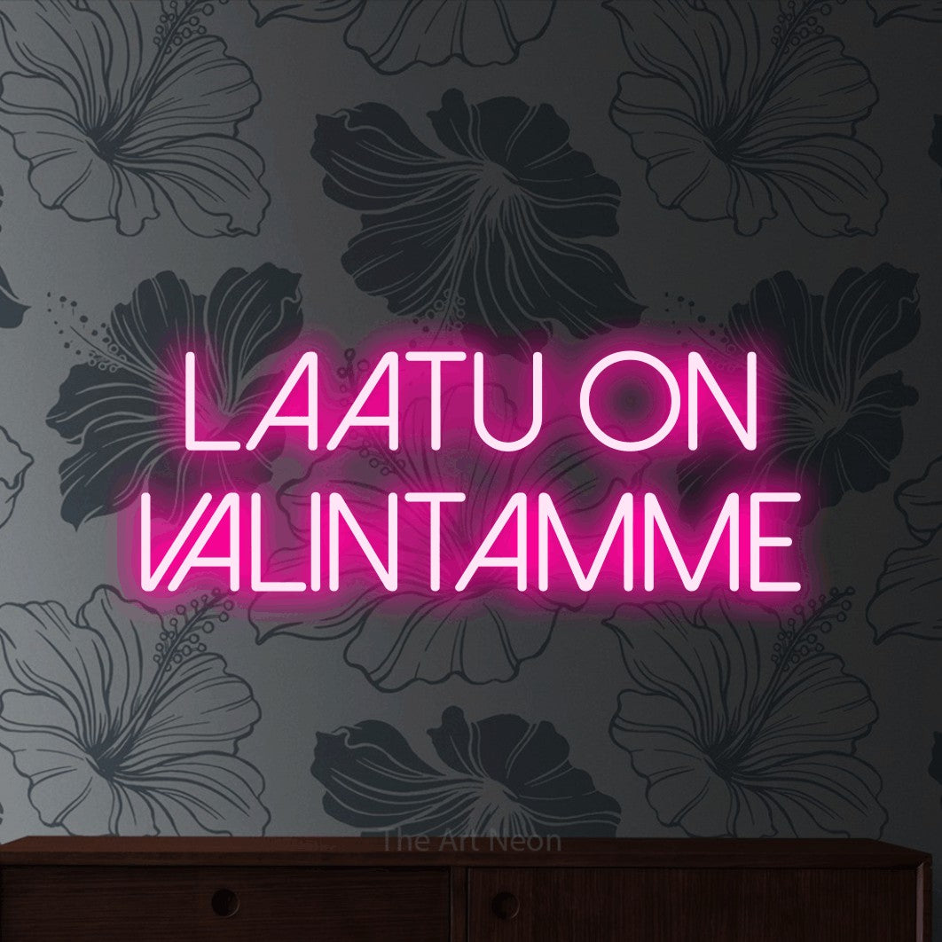 LED neon sign reading “laatu on VALINTAMME”, arranged in 2 lines.