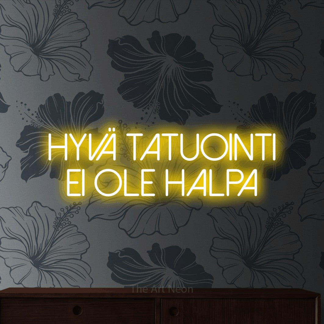 LED neon sign reading “Hyvä tatuointi ei ole halpa”, arranged in 2 lines.