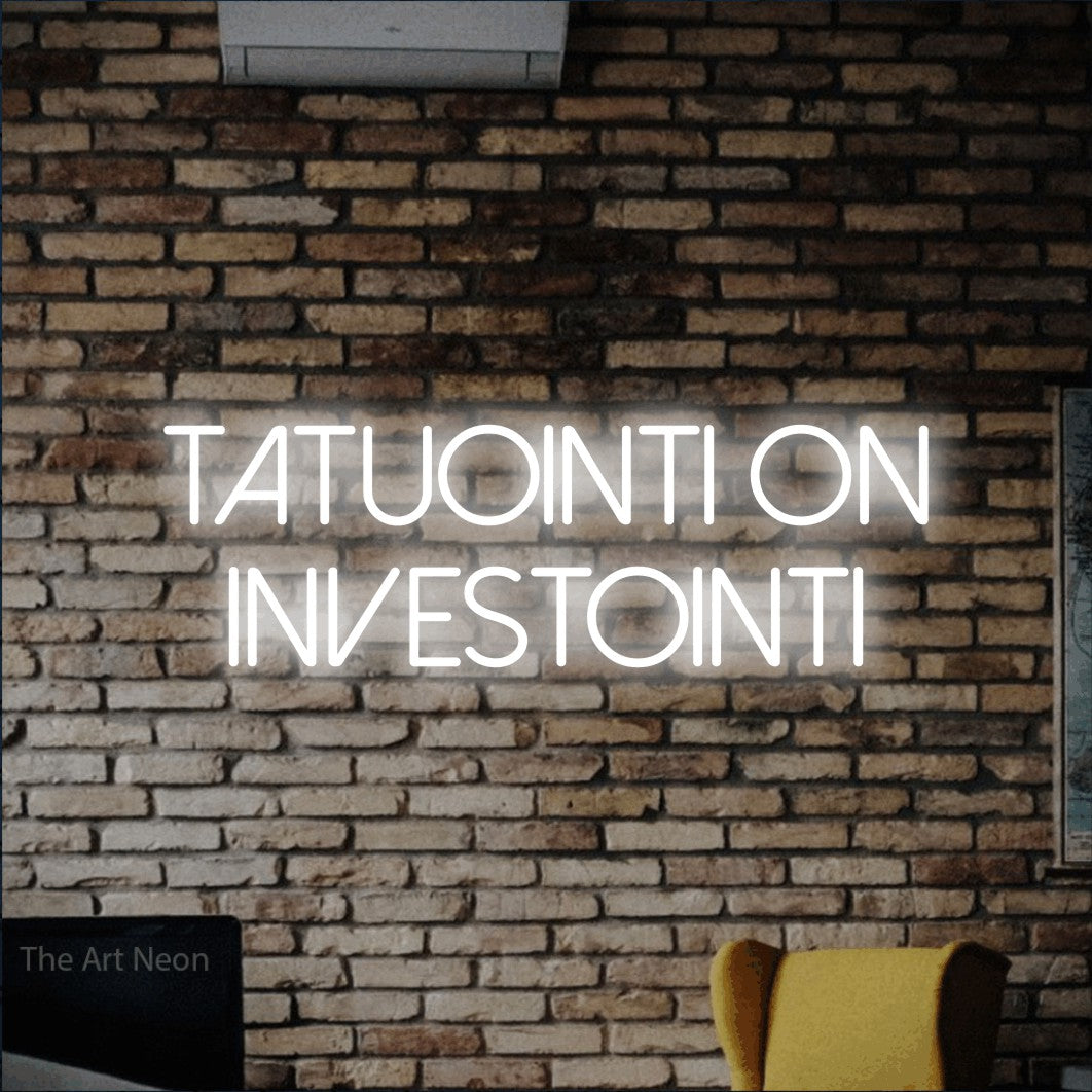 LED neon sign reading “tatuointi on INVESTOINTI”, arranged in 2 lines.