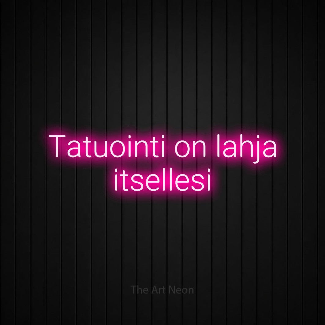 LED neon sign reading “Tatuointi on lahja itsellesi”, arranged in 2 lines.