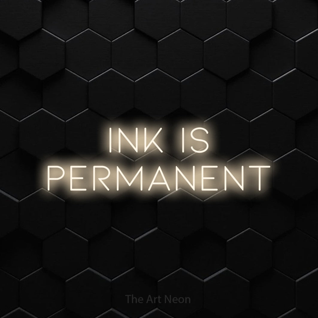 LED neon sign reading “ink is permanent”, arranged in 2 lines.