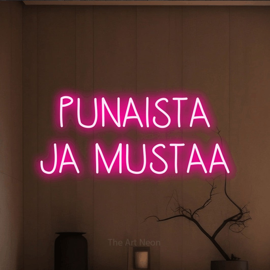 LED neon sign reading “PUNAISTA JA MUSTAA”, arranged in 2 lines.