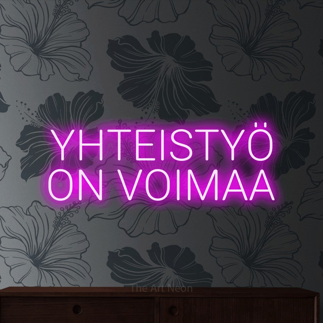 LED neon sign reading “YHTEISTYÖ ON VOIMAA”, arranged in 2 lines.