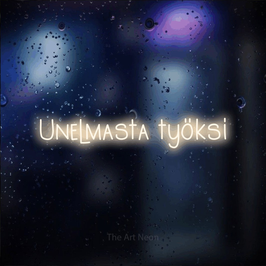LED neon sign reading “Unelmasta työksi”, arranged in a single line.