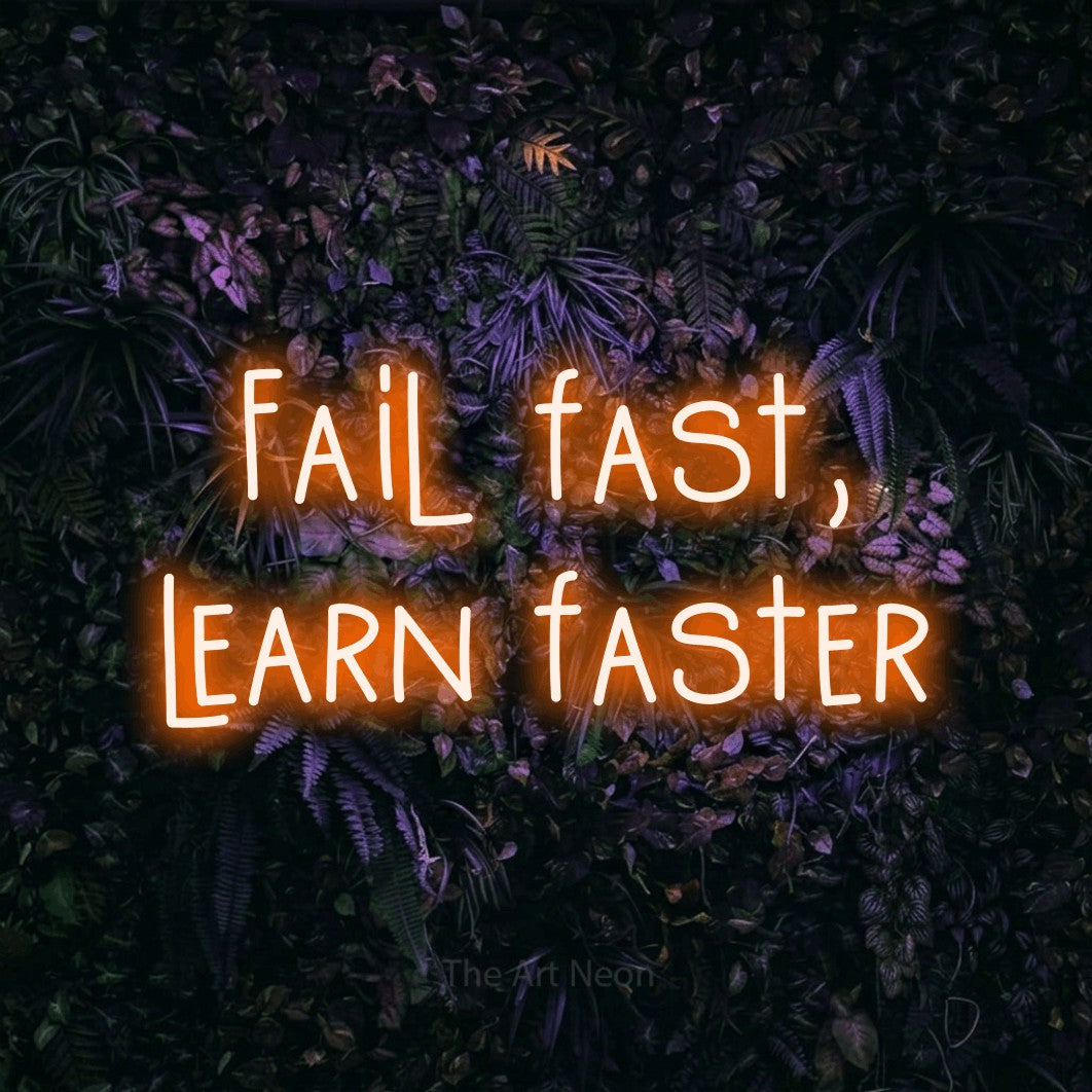 LED neon sign reading “Fail fast, learn faster”, arranged in 2 lines.