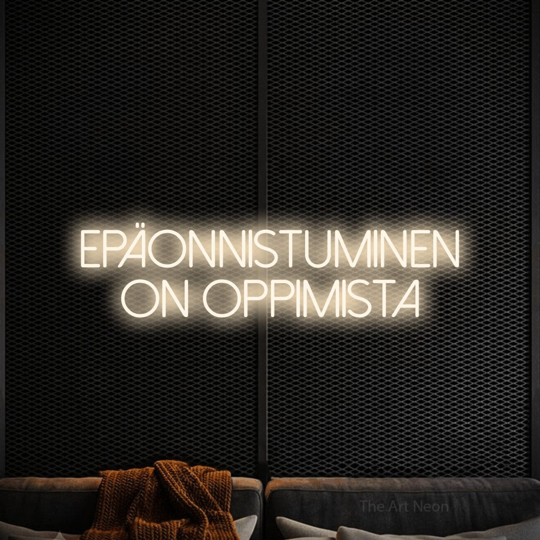 LED neon sign reading “EPÄONNISTUMINEN ON OPPIMISTA”, arranged in 2 lines.