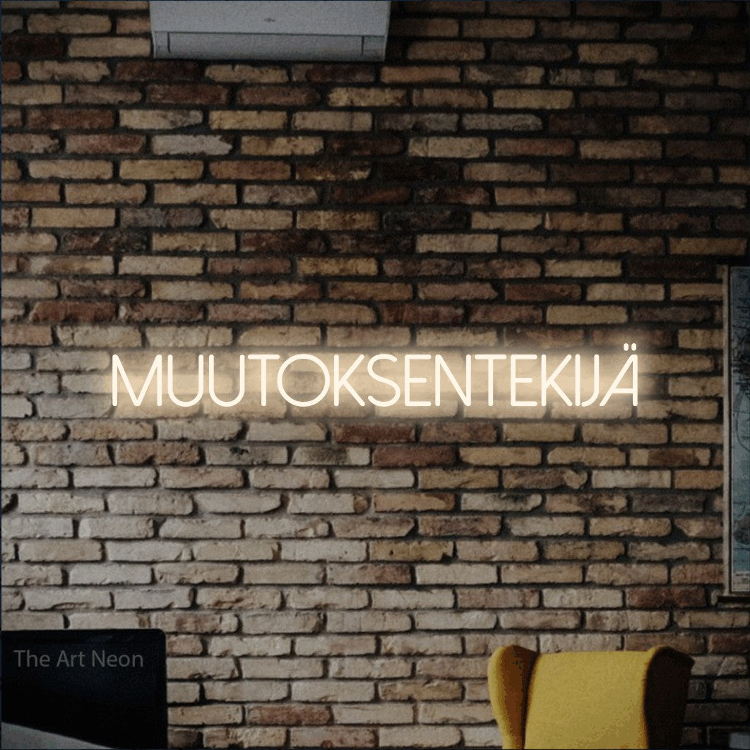 LED neon sign reading “muutoksentekijä”, arranged in a single line.
