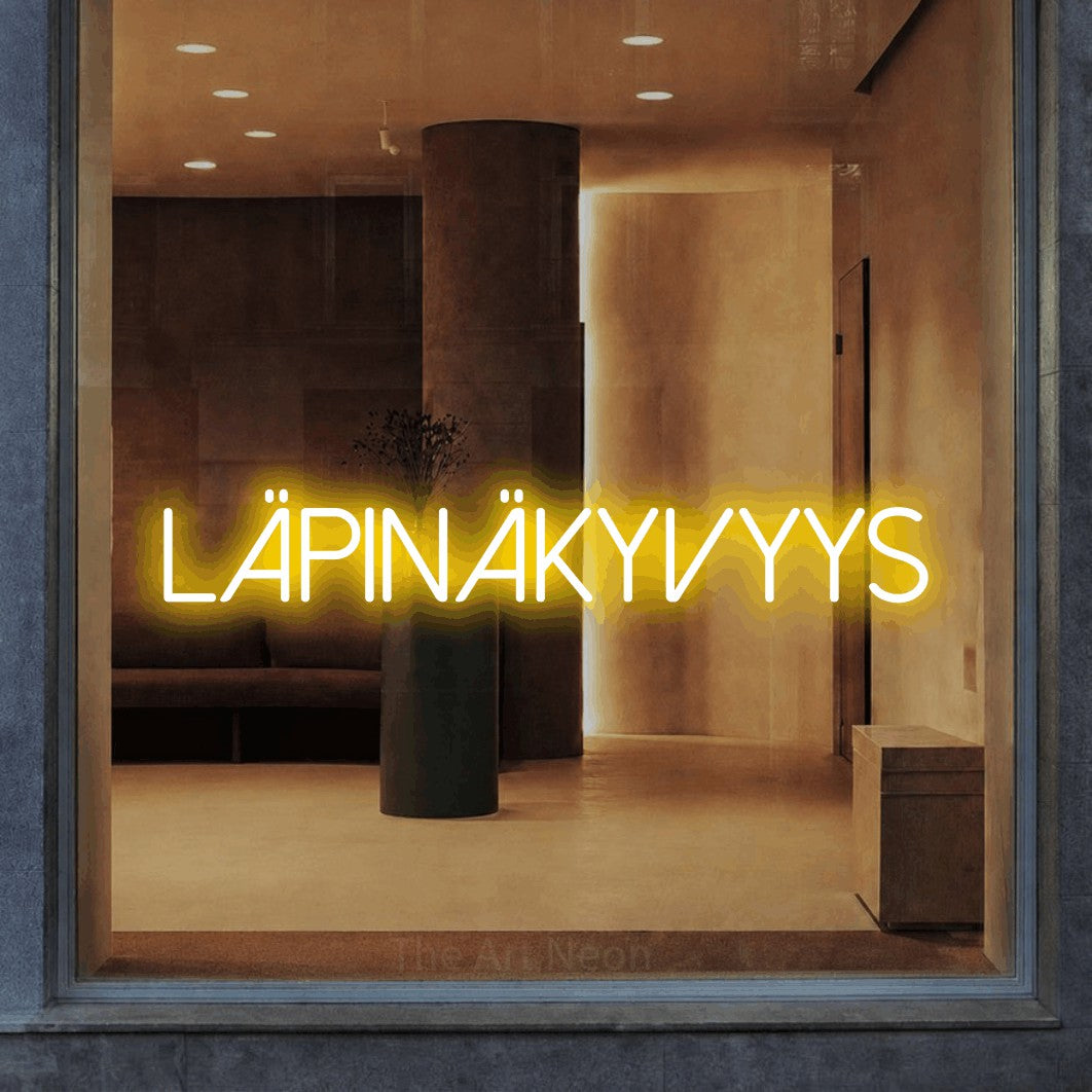 LED neon sign reading “LÄPINÄKYVYYS”, arranged in a single line.