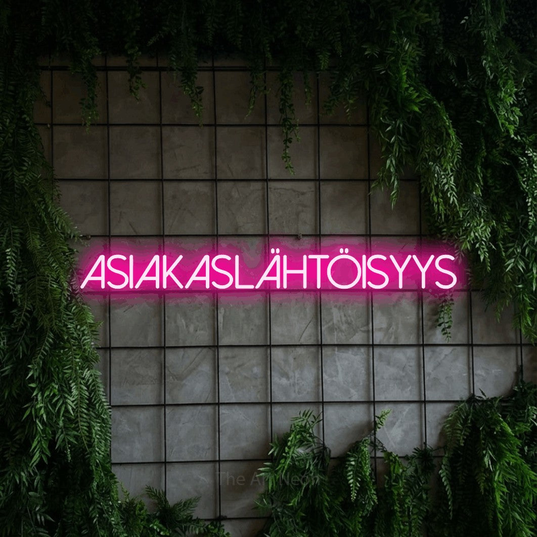 LED neon sign reading “ASIAKASLÄHTÖISYYS”, arranged in a single line.