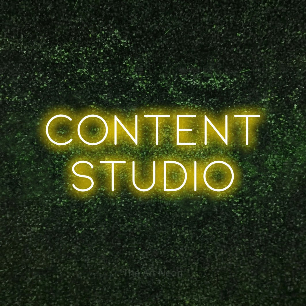 LED neon sign reading “Content studio”, arranged in 2 lines.