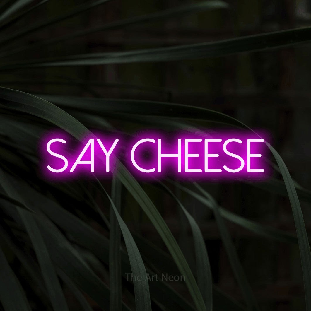 LED neon sign reading “Say cheese”, arranged in a single line.