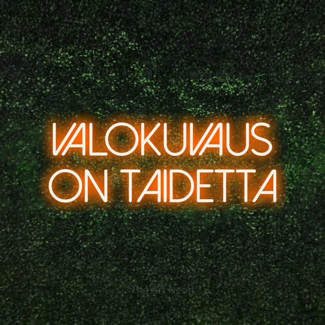 LED neon sign reading “VALOKUVAUS on taidetta”, arranged in 2 lines.
