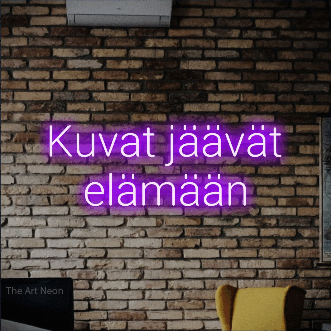 LED neon sign reading “Kuvat jäävät elämään”, arranged in 2 lines.