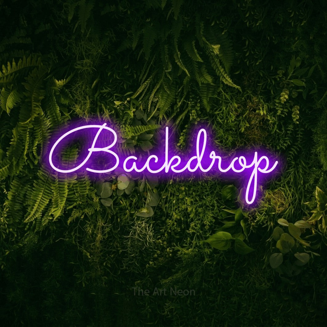 LED neon sign reading “Backdrop”, arranged in a single line.
