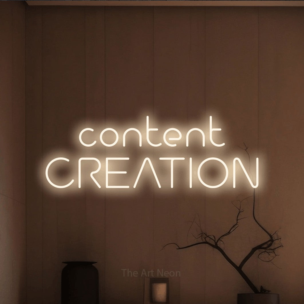 LED neon sign reading “content CREATION”, arranged in 2 lines.