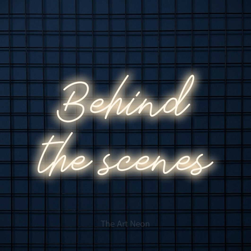 LED neon sign reading “Behind the scenes”, arranged in 2 lines.