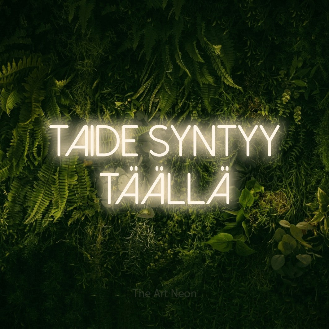LED neon sign reading “Taide syntyy täällä”, arranged in 2 lines.