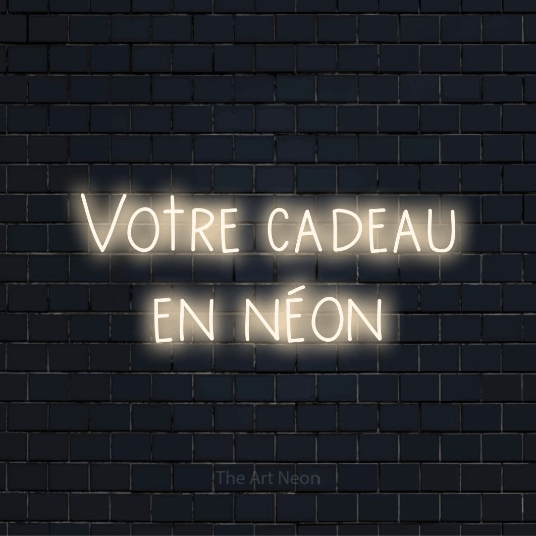 Enseigne néon personnalisée « Votre cadeau en néon » sur un mur en briques noires