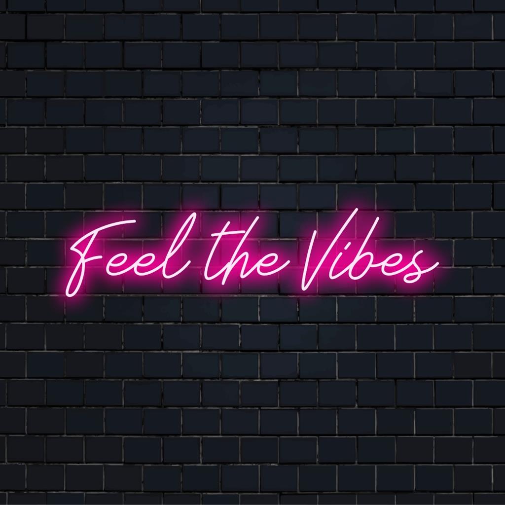 Custom LED neon sign reads Feel The Vibes, perfect for vibrant and personalized neon quote decor.