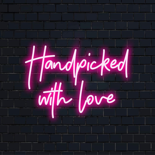 LED neon sign reading Handpicked With Love in curated artisan style, ideal for intimate spaces and bespoke wall decor.