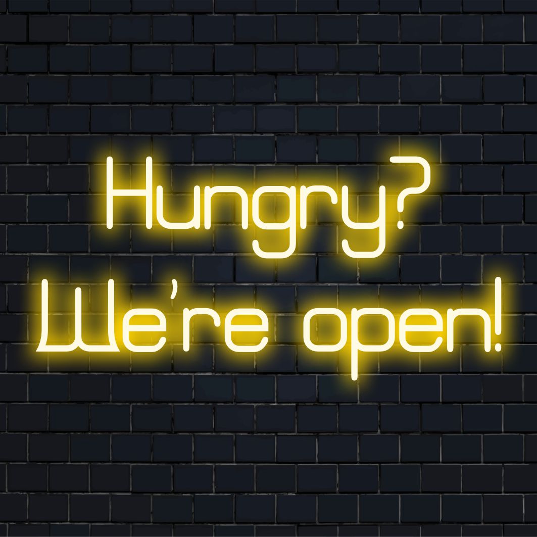LED-valokyltti lukee Hungry Olemme avoinna! eloisissa väreissä, täydellinen korostamaan mitä tahansa tilaa kutsuvalla neonvalolla.