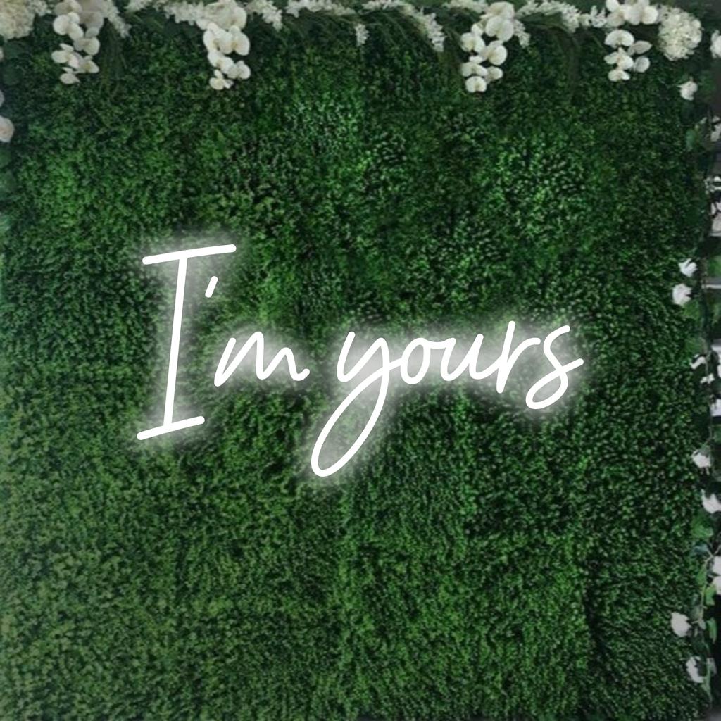 Stylish LED neon sign with 'I'm Yours' in elegant script, glowing warmly as customizable neon décor art.