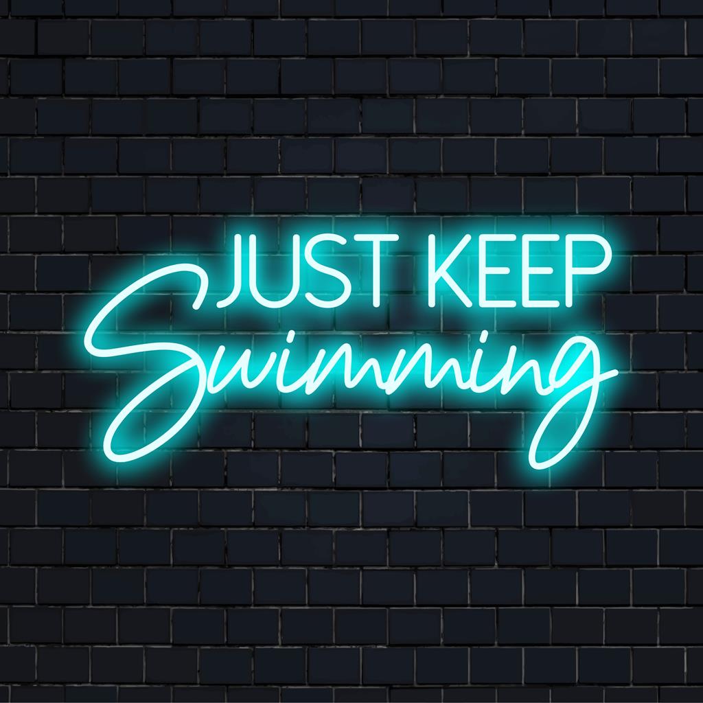 Custom-made LED neon sign displaying Just Keep Swimming in luminous colors—a vibrant neon quote art for wall decor.