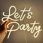 A vibrant LED neon sign displaying the words "Let's Party" in bold, cursive lettering.