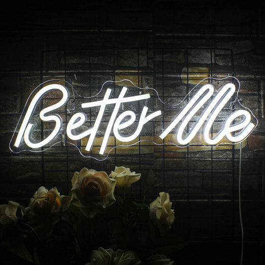 A stylish LED neon sign displaying the words "Better Me" in vibrant white cursive letters.