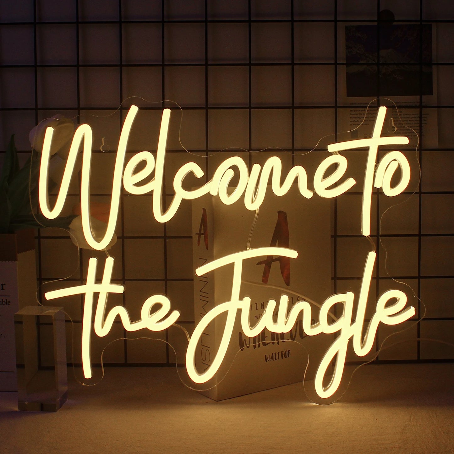 A vibrant LED neon sign displaying the phrase "Welcome to the Jungle" in bold, cursive lettering.