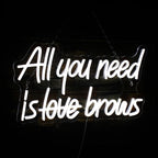 Kuvassa näkyy eloisa "All you need is brows" -LED-valokyltti.