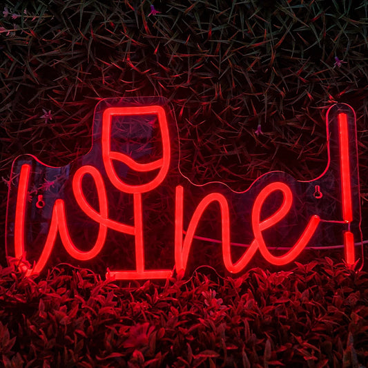 A vibrant LED neon sign glowing in a rich burgundy hue, shaping the word "Wine" in an elegant, flowing script.