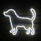 A vibrant LED neon sign shaped like a small, playful dog.