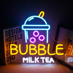 The image displays a vibrant LED neon sign in the shape of a bubble milk tea cup.
