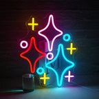 The image features a vibrant LED neon sign in the shape of a cluster of stars.