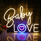 Eloisa vaaleanpunainen neonkyltti kirjoittelee sanat "Baby Love" leikkisällä, kursiivisella fontilla.