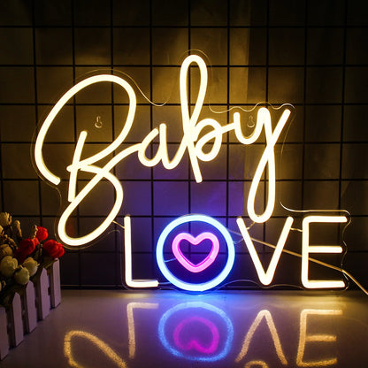 A vibrant pink neon sign spells out the words "Baby Love" in a playful, cursive font.