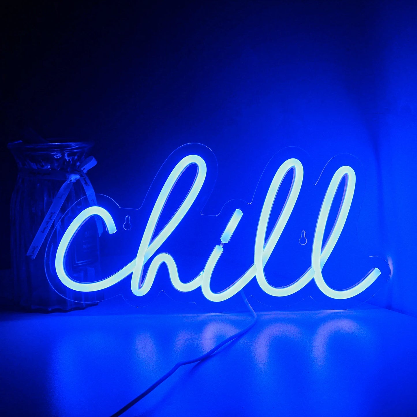Kuvassa näkyy "Chill" LED-valokyltti, jossa on sana "Chill" kirjoitettuna eloisalla, kursiivityylillä.