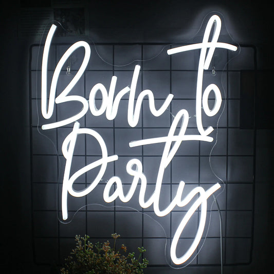 The image features a vibrant "Born to Party" LED neon sign.