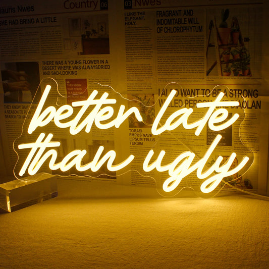 A vibrant LED neon sign displaying the phrase "Better Late Than Ugly" in a stylish handwritten script font.