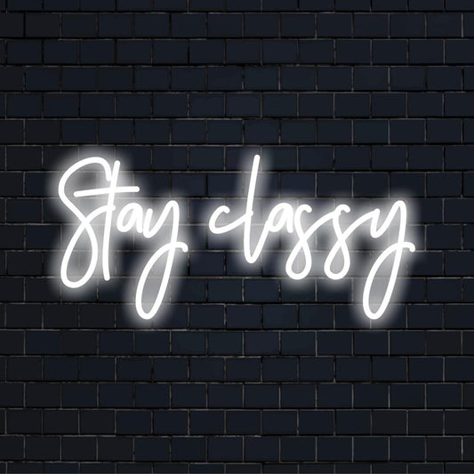 A stylish custom LED neon sign with Stay Classy illuminated in vibrant colors, perfect for chic wall decor.