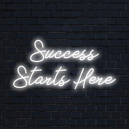 Success Starts Here' neon sign aglow, perfect custom LED quote piece for inspirational decor. Transform any space!