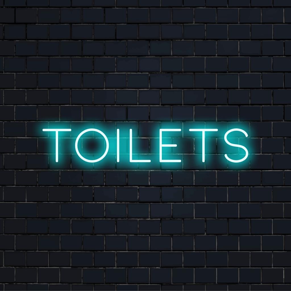 Mukautettu LED-valokyltti, jossa sana WC:t kirkkaalla, tyylikkäällä fontilla; ihanteellinen ainutlaatuiseksi neonsisustusmateriaaliksi.