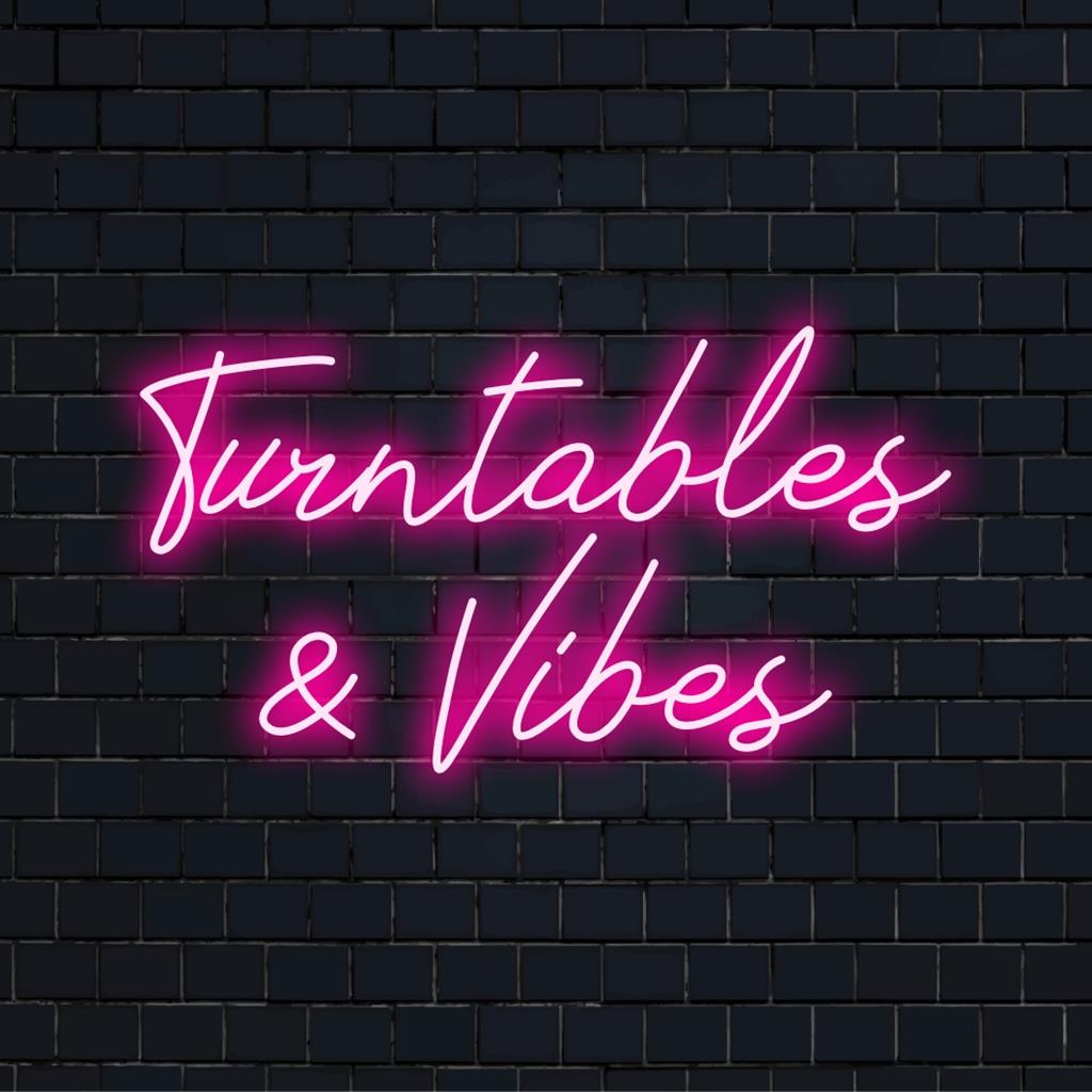 Vibrant LED neon sign crafted to emulate turntables and vibes, perfect custom art for any modern space or music enthusiast's decor.