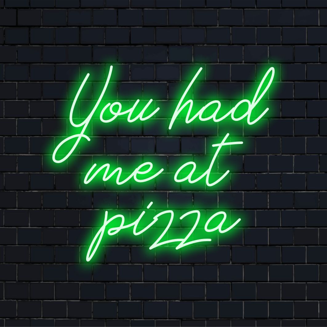 Vibrant custom LED neon sign reads You Had Me At Pizza, perfect neon wall art for adding fun to your decor.