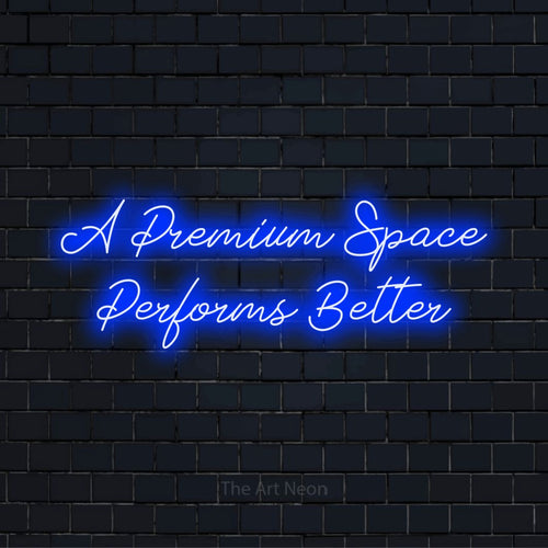 "A Premium Space Performs Better" glowing LED neon sign on a black brick wall